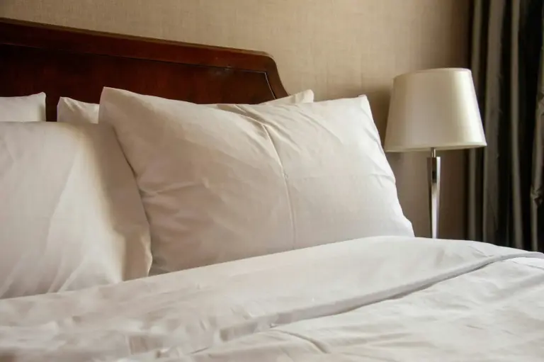 Soft white pillows on a hotel-style bed
