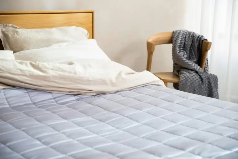 Quilted mattress on a wooden bed frame